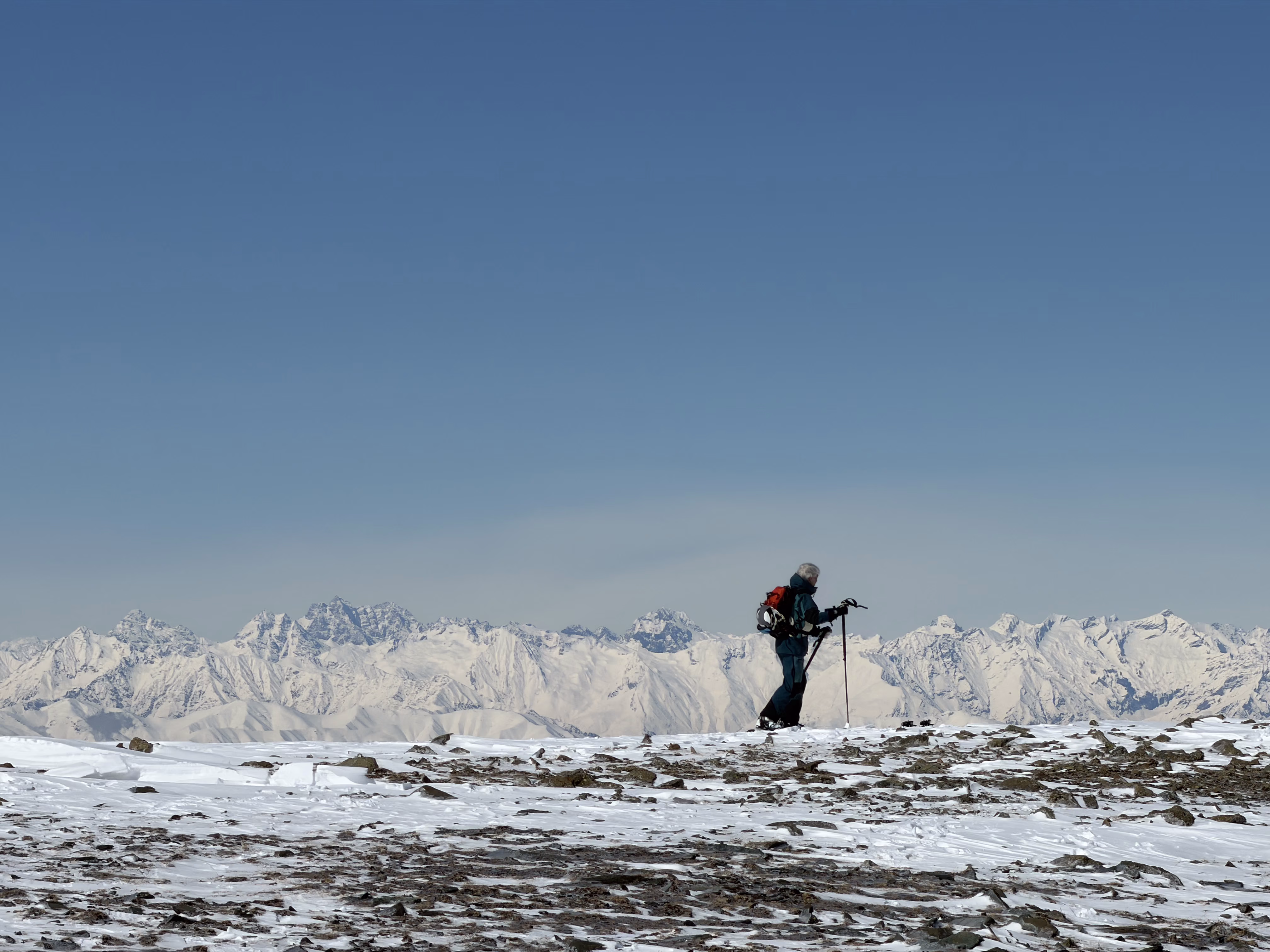 Ski tourers moving along a ridgeline on a multi-day backcountry traverse